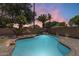 Backyard pool with lush tropical landscaping creates a private desert oasis at 1037 E Baylor Ln, Gilbert, AZ 85296