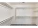 Walk-in closet with multiple shelves and rods for ample storage at 1037 E Baylor Ln, Gilbert, AZ 85296