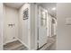 Clean basement area with vinyl floors, a utility hookup, and a doorway, with light neutral colored walls at 10516 W Peoria Ave, Sun City, AZ 85351