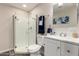 Clean bathroom featuring a glass-enclosed shower, modern fixtures, and a vanity with storage at 10516 W Peoria Ave, Sun City, AZ 85351