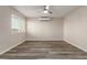 A neutral bedroom with new floors, lots of light, and a ceiling fan at 10516 W Peoria Ave, Sun City, AZ 85351
