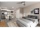 Cozy bedroom featuring a comfortable bed, stylish decor, and an open-concept kitchen/dining area at 10516 W Peoria Ave, Sun City, AZ 85351