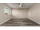 Bright bedroom with new hardwood floors, ceiling fan, window, and modern A/C unit at 10516 W Peoria Ave, Sun City, AZ 85351