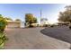 Exterior shot of house with a curved driveway and well-maintained landscaping at 10516 W Peoria Ave, Sun City, AZ 85351