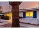 House at dusk with blue window shutters and a palm tree in the front at 10516 W Peoria Ave, Sun City, AZ 85351