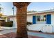Exterior of a white home featuring gravel landscaping and bright blue window shutters at 10516 W Peoria Ave, Sun City, AZ 85351