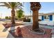 Charming home featuring mature palm trees, gravel landscaping, and bright blue window shutters at 10516 W Peoria Ave, Sun City, AZ 85351