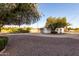 Exterior of a house with gravel landscaping and mature trees at 10516 W Peoria Ave, Sun City, AZ 85351