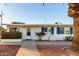 Charming single-story home with blue shutters and manicured front yard at 10516 W Peoria Ave, Sun City, AZ 85351