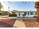 Inviting one-story home with blue shutters and manicured front yard at 10516 W Peoria Ave, Sun City, AZ 85351