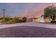 House with desert landscaping, circular driveway and white exterior paint at 10516 W Peoria Ave, Sun City, AZ 85351