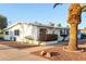 Well-kept single-story home with blue shutters and desert landscaping at 10516 W Peoria Ave, Sun City, AZ 85351