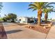 Single-story house with mature palms, wide driveway and desert landscaping at 10516 W Peoria Ave, Sun City, AZ 85351