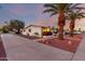 Charming home exterior with palm trees, a well-maintained lawn, and a wide driveway at 10516 W Peoria Ave, Sun City, AZ 85351