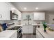 Well-lit kitchen showcasing white cabinets, stainless steel appliances, and a functional layout at 10516 W Peoria Ave, Sun City, AZ 85351