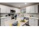 Bright kitchen with white cabinets, stainless steel appliances, and an island with decorative place settings at 10516 W Peoria Ave, Sun City, AZ 85351