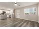 Open-concept living room and kitchen with stainless steel appliances and new floors at 10516 W Peoria Ave, Sun City, AZ 85351