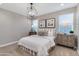 Bedroom featuring stylish lighting, two windows and patterned pillows at 10619 W Bloch Rd, Tolleson, AZ 85353