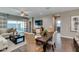 Bright open-concept dining area featuring a table with seating for four, and living area with sliding glass doors at 10619 W Bloch Rd, Tolleson, AZ 85353