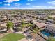 A captivating aerial view of a charming residential neighborhood with lush landscaping and community park at 1124 E Jahns Dr, Casa Grande, AZ 85122