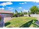 Expansive backyard featuring lush green lawn, mature landscaping, and privacy fence perfect for entertaining at 1124 E Jahns Dr, Casa Grande, AZ 85122