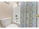 Bathroom with a toilet, shower-tub combo, and a colorful shower curtain at 1124 E Jahns Dr, Casa Grande, AZ 85122