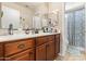 Bathroom vanity featuring dark wood cabinets, a mirror and access to a shower/tub combo at 1124 E Jahns Dr, Casa Grande, AZ 85122