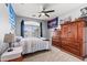 Comfortable bedroom featuring a window, fan, and wood furniture at 1124 E Jahns Dr, Casa Grande, AZ 85122