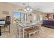 Charming dining area with a rustic table, bench, and natural light streaming through large windows at 1124 E Jahns Dr, Casa Grande, AZ 85122