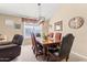 Cozy dining room with a wooden table, comfortable seating, and natural light from the window at 1124 E Jahns Dr, Casa Grande, AZ 85122