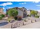Lovely front yard with desert landscaping, decorative rocks, small flowering bushes, and a paved walkway at 1124 E Jahns Dr, Casa Grande, AZ 85122