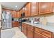 Well-equipped kitchen with stainless steel appliances, wood cabinets, and granite countertops at 1124 E Jahns Dr, Casa Grande, AZ 85122