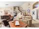 Open-concept living room with comfortable seating, a view of the staircase, and access to the dining area at 1124 E Jahns Dr, Casa Grande, AZ 85122