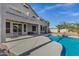 This backyard has a large pool, a patio, and mature trees and landscaping at 11257 E Reginald Ave, Mesa, AZ 85212