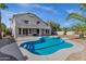 This backyard has a large pool, a patio, and mature trees and landscaping at 11257 E Reginald Ave, Mesa, AZ 85212