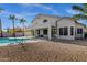 This backyard has a large pool, a patio, and mature trees at 11257 E Reginald Ave, Mesa, AZ 85212