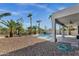 This backyard has a large pool, gravel landscaping, and mature trees at 11257 E Reginald Ave, Mesa, AZ 85212