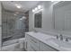This bathroom features double sinks, modern lighting, and a glass-enclosed shower at 11257 E Reginald Ave, Mesa, AZ 85212