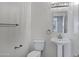 Stylish half-bathroom with pedestal sink, modern lighting fixture, and neutral color palette at 11257 E Reginald Ave, Mesa, AZ 85212