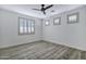 Bright bedroom with natural light, neutral walls, and stylish wood-style flooring, creating a serene space at 11257 E Reginald Ave, Mesa, AZ 85212