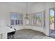 Cozy dining area with plenty of natural light, elegant light fixture, and wood floors at 11257 E Reginald Ave, Mesa, AZ 85212