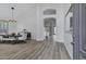 Bright dining room with wood floors, high ceilings, stylish lighting, and open view to the kitchen at 11257 E Reginald Ave, Mesa, AZ 85212