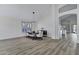 Spacious dining area featuring wood-look floors, high ceilings, contemporary lighting, and plantation shutters at 11257 E Reginald Ave, Mesa, AZ 85212