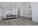 Open-concept dining area with wood floors, high ceilings, and views to a stairway and entryway at 11257 E Reginald Ave, Mesa, AZ 85212