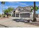 Charming two-story home featuring a three-car garage, desert landscaping, and mature palm trees at 11257 E Reginald Ave, Mesa, AZ 85212