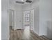 Hallway showcasing stylish flooring, neutral walls, and multiple doorways to adjacent rooms at 11257 E Reginald Ave, Mesa, AZ 85212