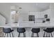 Eat-in kitchen with quartz countertops, seating, and black hardware and appliances at 11257 E Reginald Ave, Mesa, AZ 85212