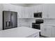 Bright kitchen with plenty of storage, black stainless appliances, and quartz countertops at 11257 E Reginald Ave, Mesa, AZ 85212