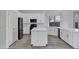 Eat-in kitchen features an island, black appliances, and quartz countertops at 11257 E Reginald Ave, Mesa, AZ 85212