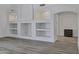 Bright living room featuring built-in shelves, wood floors, and neutral decor at 11257 E Reginald Ave, Mesa, AZ 85212
